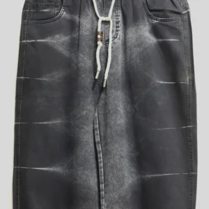 Men's black baggy jeans with vertical white side stripes paired with streetwear sneakers