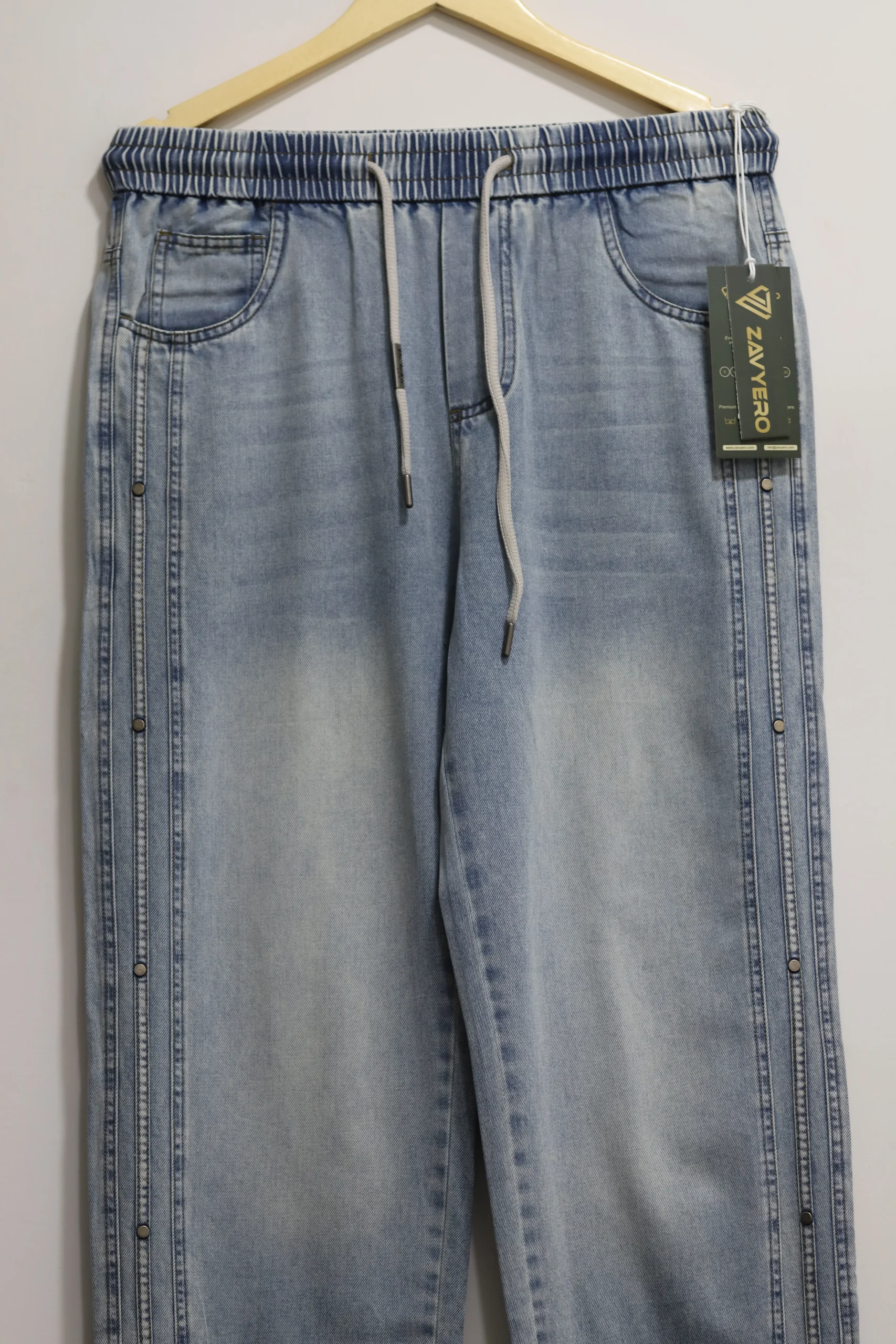 Light blue baggy denim jeans with elastic drawstring waist and side stud rivet details