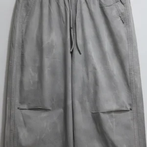 Men's grey baggy fit casual trousers folded cleanly for smart-casual look